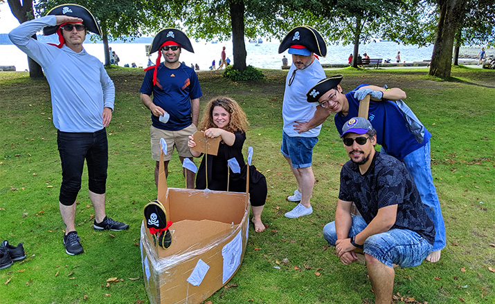 a group of teammates doing a cardboard boat building challenge